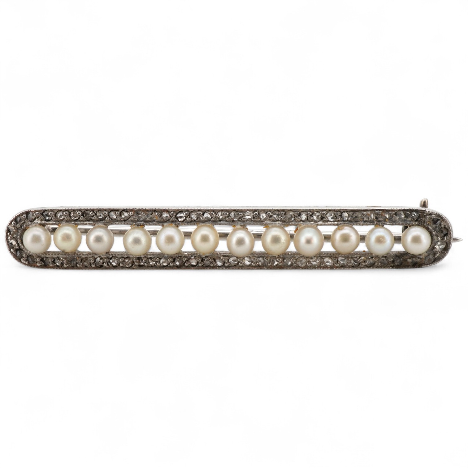 A Belle Epoque pearl and diamond brooch, early 20th century, of bar design, composed of a line of seed pearls within an oval border of rose-cut diamonds, mounted in platinum, length 3.9cm, French sponsor's mark, partial